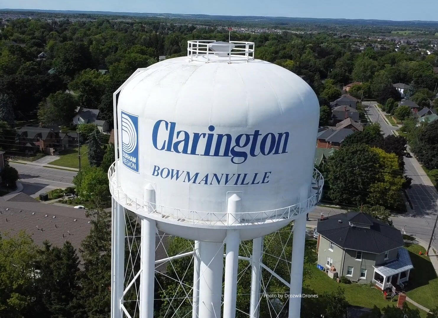 An aerial photograph of a white water tower. The Durham region logo and words "Clarington Bowmanville" are in blue.